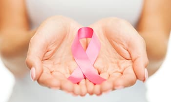 Lady Hold Cancer Ribbon — Health Specialists on Fraser Coast, QLD
