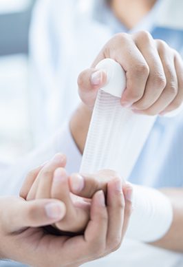 Putting Bandage on Hand — Health Specialists on Fraser Coast, QLD