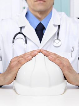 Doctor Holding Safety Hat — Health Specialists on Fraser Coast, QLD