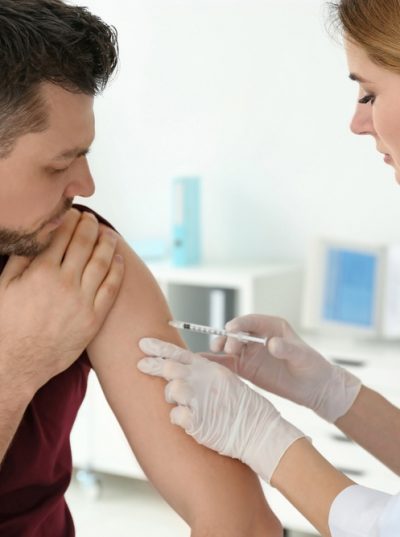 Female Doctor Vaccinating Young Man — Health Specialists on Fraser Coast, QLD